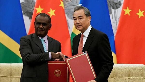 <div class="paragraphs"><p>Chinese State Councilor and Foreign Minister Wang Yi shakes hands with Jeremiah Manele.</p></div>