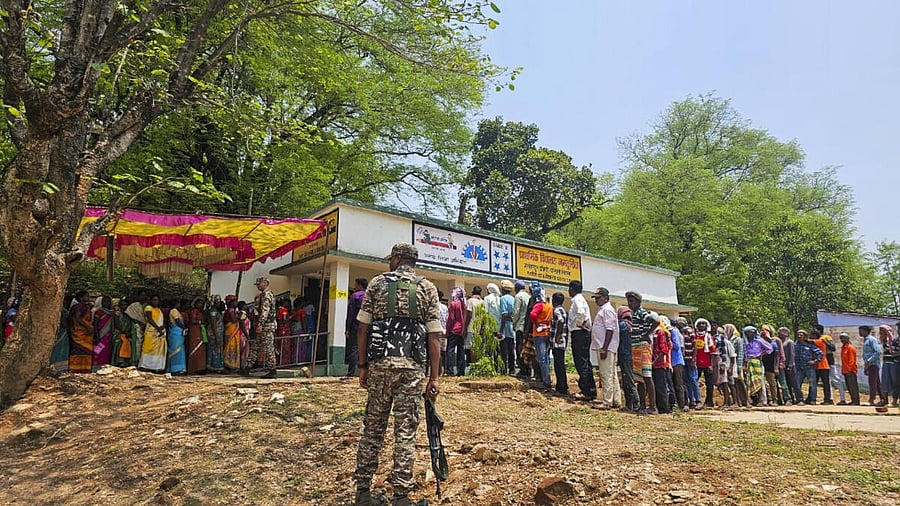 <div class="paragraphs"><p>People wait in queues to cast their votes at a polling booth during the fourth phase of Lok Sabha elections.</p></div>