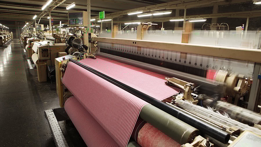 Weaving crisscross fabric on air jet looms in a textile weaving unit.
Textile Production - Weaving Cotton Fabric on Airjet Looms