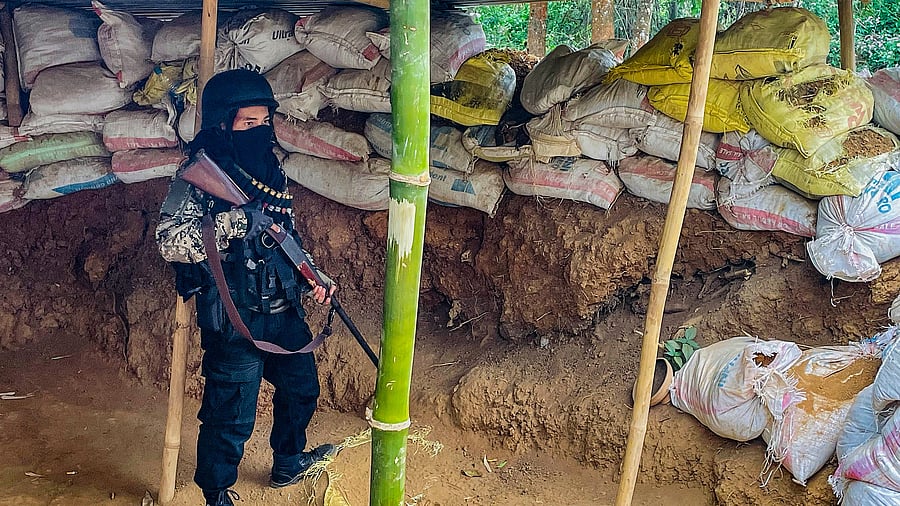 <div class="paragraphs"><p>A 'village volunteer' stands guard at a bunker set up in conflict-hit Manipur.</p></div>