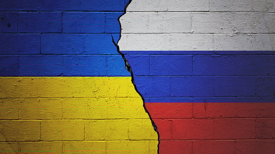 <div class="paragraphs"><p>Cracked brick wall painted with a Ukrainian flag on the left and a Russian flag on the right.</p></div>