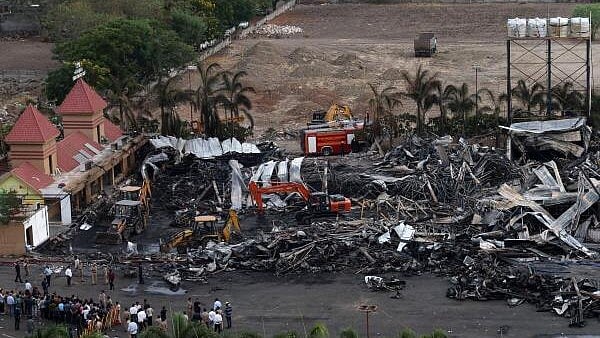 <div class="paragraphs"><p>Machines move debris following a fire in a gaming zone in Rajkot, in the western state of Gujarat, India, May 26, 2024.</p></div>