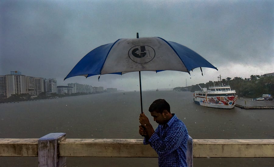<div class="paragraphs"><p>A man holds an umbrella during rains in the backdrop of Kochi backwaters, in Kochi, Wednesday, May 29, 2024.  </p></div>