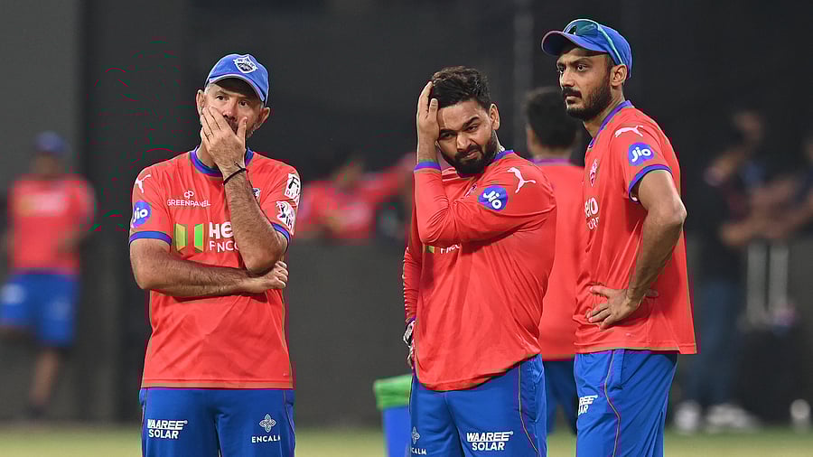 <div class="paragraphs"><p>Delhi Capitals head coach Ricky Ponting (left) chats with Rishabh Pant (centre) and Axar Patel during a practice session ahead of their game against Royal Challengers Bengaluru at M Chinnaswamy Stadium on Saturday. </p></div>