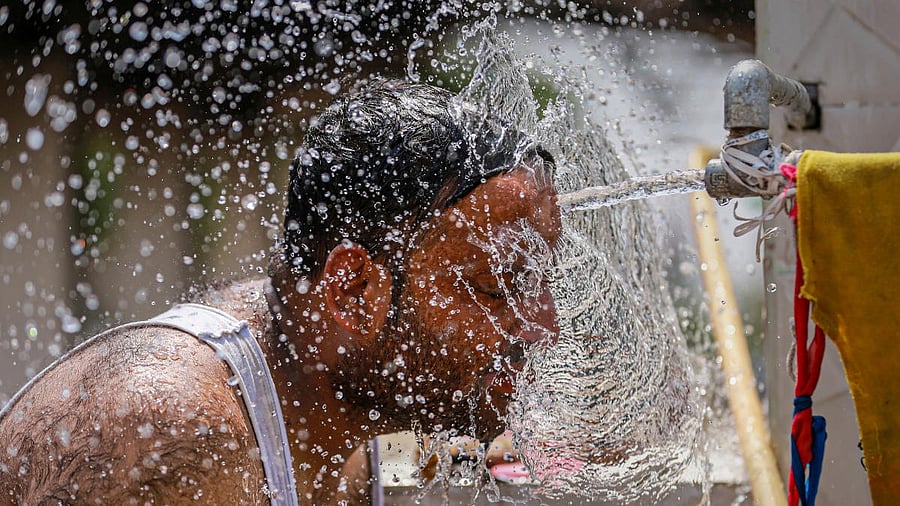 <div class="paragraphs"><p>A man cools off from tap water during a hot summer day.</p></div>