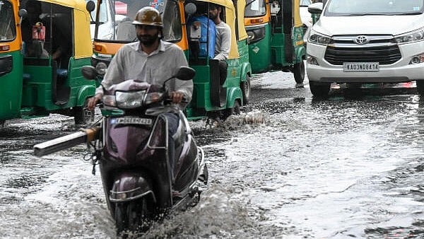 <div class="paragraphs"><p>Motorists are drive through rain water, as following winds and rain, in the City.</p></div>