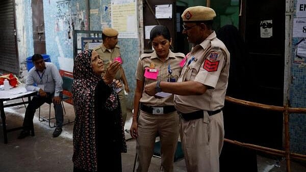 <div class="paragraphs"><p>Members of the police help an elderly woman locate the polling station on the day of the sixth phase of the general election in the old quarters of Delhi, India, May 25, 2024. </p></div>