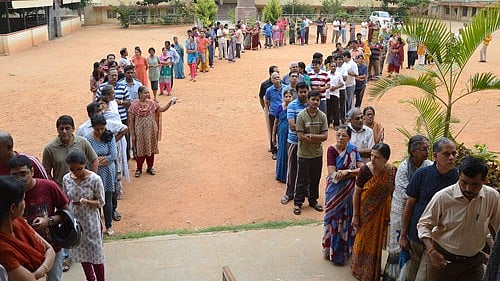 <div class="paragraphs"><p>People in queue to cast their votes.</p></div>