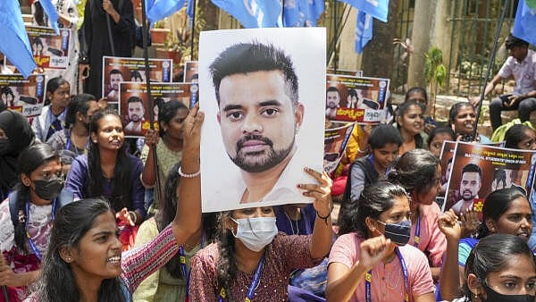 <div class="paragraphs"><p>A poster of Prajwal Revanna is held up during protests against his alleged sex abuse</p></div>
