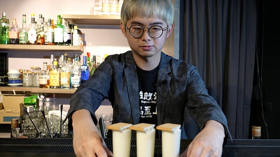 <div class="paragraphs"><p>Powei Lee, 31, owner of Kinmen Mojo Bar, displays for the camera the "Pick and Eat" cocktail, in Kinmen Island, Taiwan, May 25, 2024. </p></div>