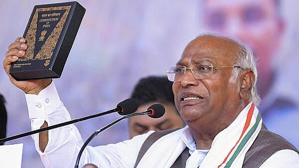 <div class="paragraphs"><p>Congress President Mallikarajun Kharge holds the Constitution of India.</p></div>