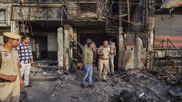 <div class="paragraphs"><p>A forensic expert collects samples from site of the fire at the New Born Baby Care Hospital, in east Delhi.</p></div>