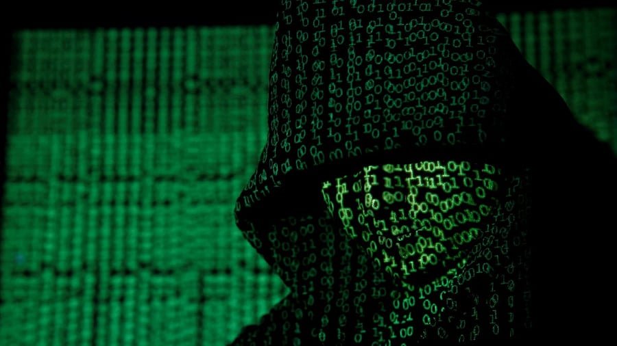 <div class="paragraphs"><p>A projection of cyber code on a hooded man is pictured in this illustration.</p></div>