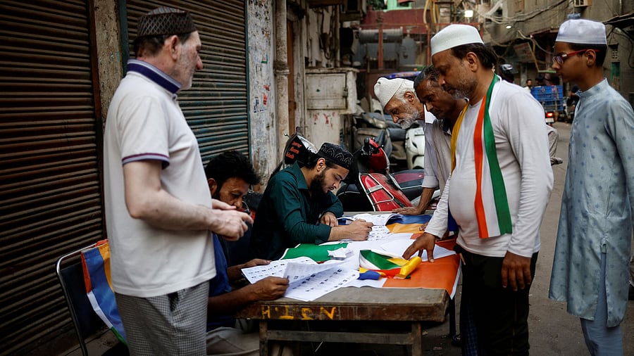 <div class="paragraphs"><p>People check their names in the voters list outside a polling station on the day of the sixth phase of the general election in the old quarters of Delhi, India, May 25, 2024.</p></div>