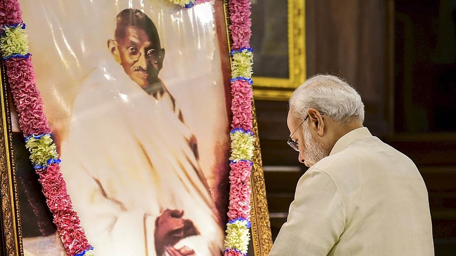 <div class="paragraphs"><p>File photo of PM Narendra Modi paying tribute to Mahatma Gandhi. </p></div>