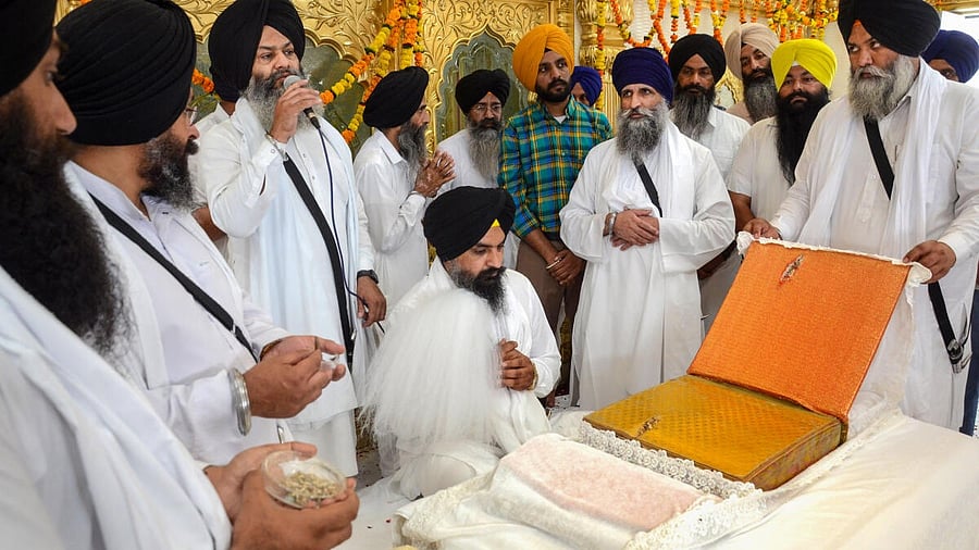 <div class="paragraphs"><p>File photo of Sikh priests displaying a copy of Guru Granth Sahib that is said to have been hit by a bullet during Operation Blue Star of 1984, on the 39th anniversary of the operation, in Amritsar. </p></div>