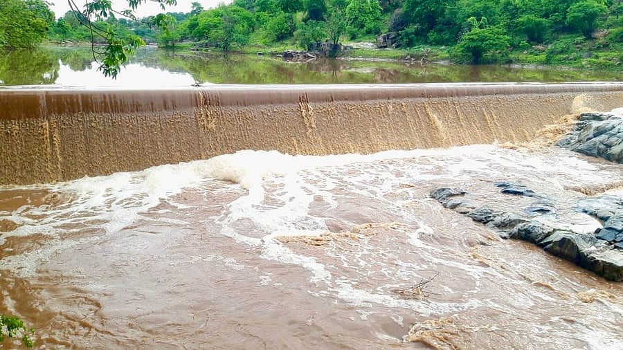 A check dam breaches following heavy rain, in Sandanapalya village of Hanur taluk in Chamarajanagar district on Thursday. 