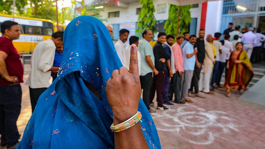 <div class="paragraphs"><p>A veiled woman shows her finger marked with indelible ink after casting her vote at a polling station. Image for representation only. </p></div>