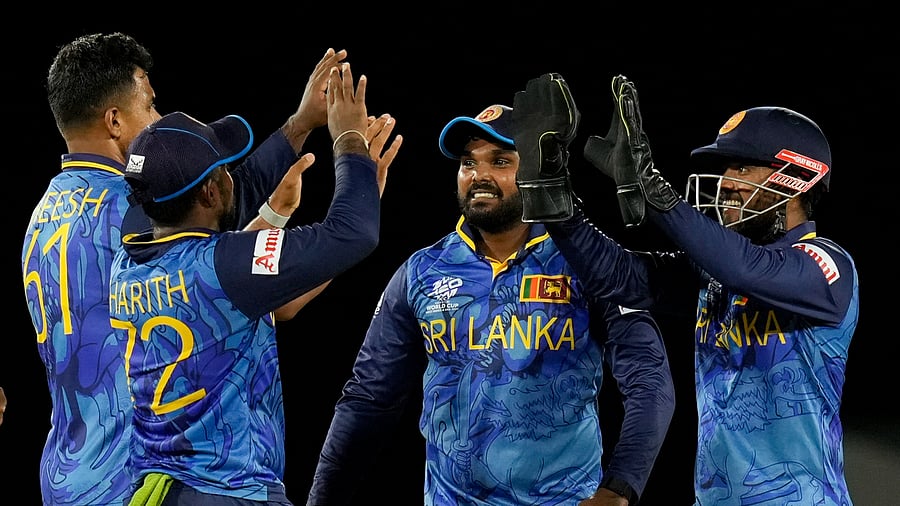 <div class="paragraphs"><p>Sri Lanka's Kusal Mendis right celebrates with teammates after stumping Michael Levitt of the Netherlands during an ICC Men's T20 World Cup cricket match at Daren Sammy National Cricket Stadium in Gros Islet, Saint Lucia, Sunday, June 16, 2024.</p></div>