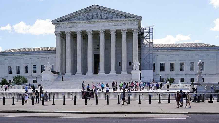 <div class="paragraphs"><p>People walk outside the US Supreme Court after justices agreed to decide the legality of a Republican-backed ban in Tennessee on gender affirming medical care for transgender minors.</p></div>