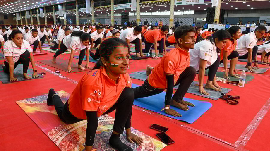 <div class="paragraphs"><p>Yoga enthusiasts gather together to perform a variety of asanas in Bengaluru on Friday. </p></div>