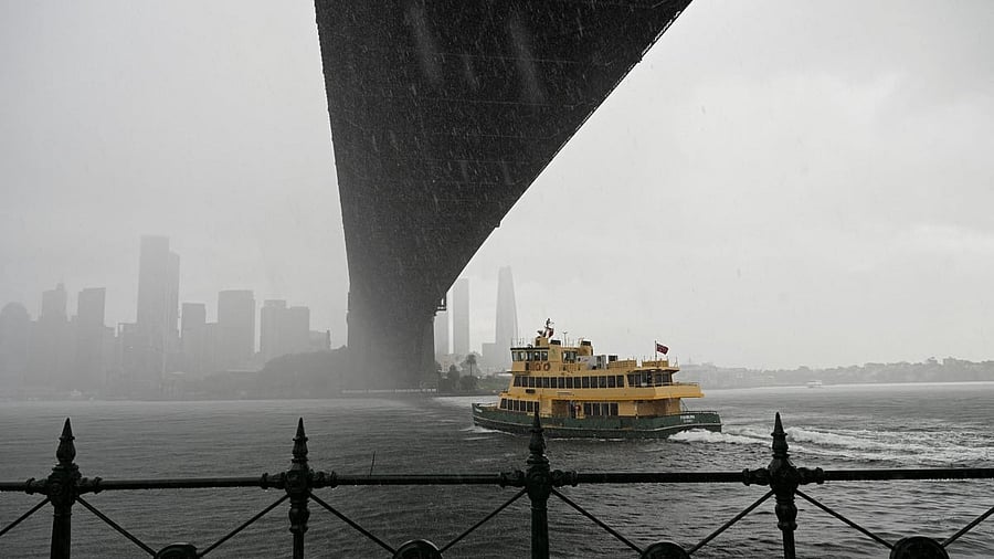 <div class="paragraphs"><p>A passenger ferry travels under the Sydney Harbour Bridge during a heavy downpour.</p></div>