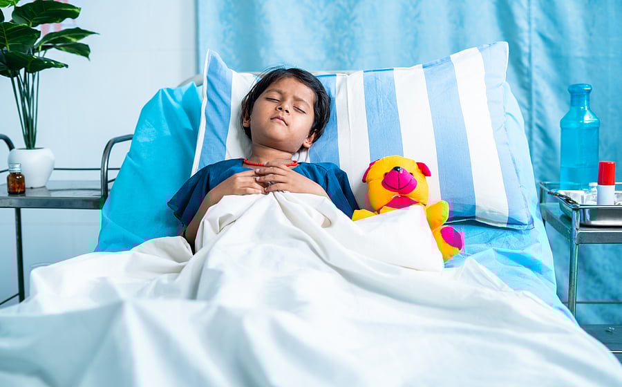 Sick girl child with teddy bear sleeping on bed at hospital - concept of medial treatment, illness and childcare
Children and Fever