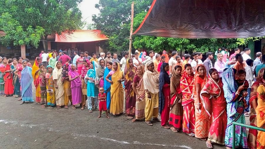 <div class="paragraphs"><p>People wait a polling station to cast their votes in Jharkhand.</p></div>