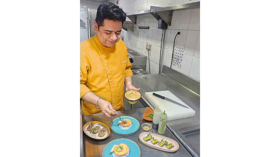 <div class="paragraphs"><p>Chef Vikas Seth plating appetisers.</p></div>