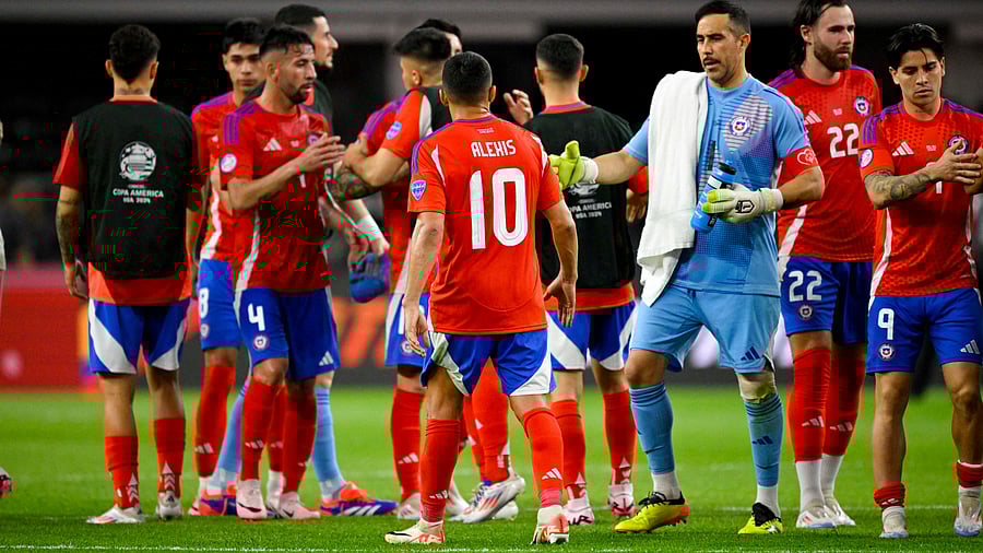 <div class="paragraphs"><p>The Chile team hugs on the field after they finish the game with a 0-0 draw with Peru in a 2024 Copa America match at AT&T Stadium. </p></div>