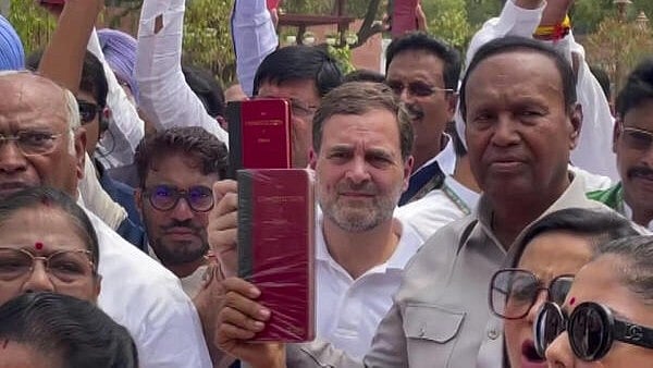 <div class="paragraphs"><p>Congress leader Rahul Gandhi and other INDIA bloc leaders show copies of the Constitution of India during their protest at the Parliament House complex on the first day of the first session of the 18th Lok Sabha, in New Delhi, Monday. </p></div>
