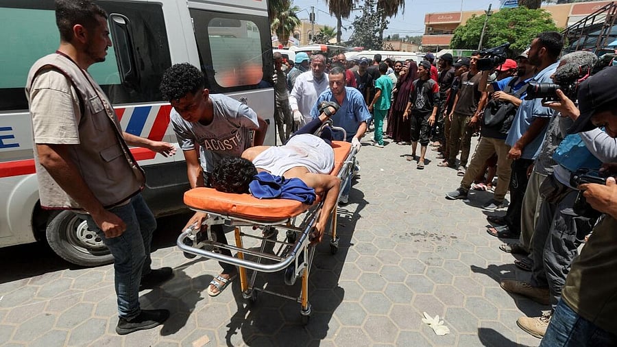 <div class="paragraphs"><p>Palestinians carry a casualty on a stretcher in the aftermath of an Israeli strike, amid the Israel-Hamas conflict, at Al-Aqsa Martyrs Hospital in Gaza. </p></div>