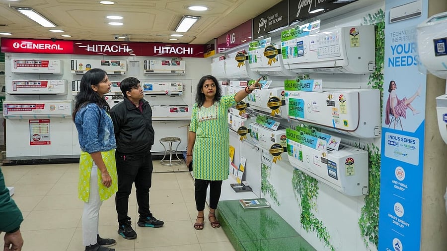 <div class="paragraphs"><p>Customers look at air conditioners at an electronics store in Kolkata.</p></div>