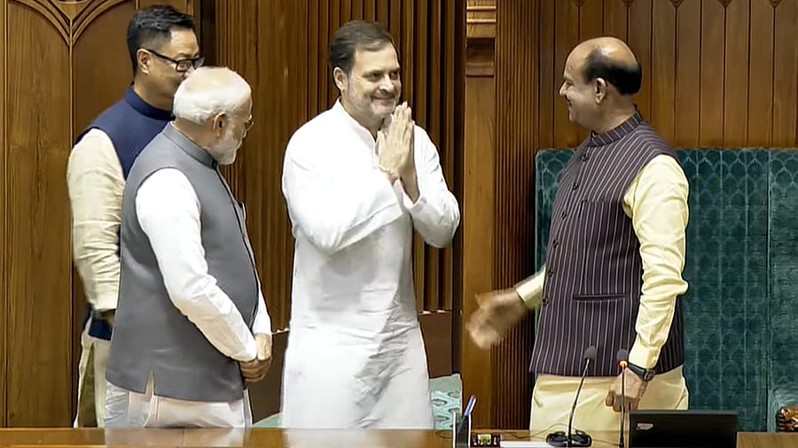 <div class="paragraphs"><p>Prime Minister Narendra Modi, Leader of the Opposition Rahul Gandhi and Union Minister for Parliamentary Affairs Kiren Rijiju greet Om Birla after the latter was elected as the Speaker of the House during the first session of the 18th Lok Sabha, in New Delhi, Wednesday, June 26, 2024. </p></div>