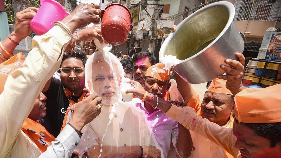 <div class="paragraphs"><p>Supporters pour milk on a poster of Narendra Modi before his swearing-in ceremony for a 3rd consecutive term, in Patna on Sunday, June 9, 2024. </p></div>