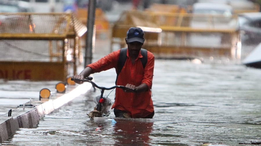 <div class="paragraphs"><p>A man wades through water in Delhi.  </p></div>