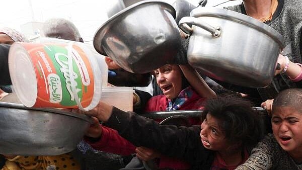 <div class="paragraphs"><p>Palestinian children wait to receive food cooked by a charity kitchen amid shortages of food supplies, as the ongoing conflict between Israel and the Palestinian Islamist group Hamas continues, in Rafah, in the southern Gaza Strip.</p></div>