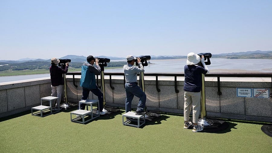 <div class="paragraphs"><p>People look towards the north through a pair of binoculars from the observation deck near the demilitarized zone that separates the two Koreas in Paju, South Korea.</p></div>