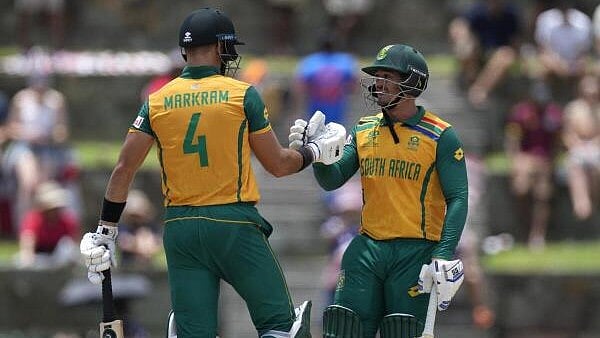 <div class="paragraphs"><p>(L to R) South Africa's captain Aiden Markram, and Quinton de Kock celebrate the partnership of 100 runs during the ICC Men's T20 World Cup cricket match between the United States and South Africa at Sir Vivian Richards Stadium in North Sound, Antigua and Barbuda, Wednesday, June 19, 2024.</p></div>