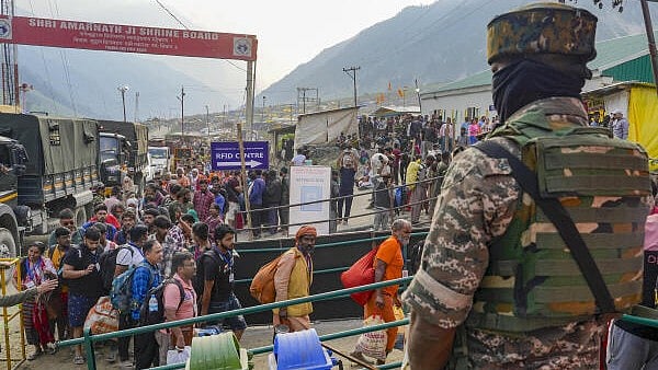 <div class="paragraphs"><p>A security personnel stands guard as the first batch of pilgrims for the annual Amarnath Yatra arrives amid tight security, at Baltal, Sonamarg of Ganderbal district of South Kashmir.</p></div>