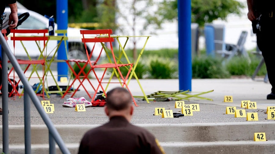 <div class="paragraphs"><p>Evidence markers indicate the position of spent shell casings following a mass shooting at the Brooklands Plaza Splash Pad in Rochester Hills, Michigan, US.</p></div>
