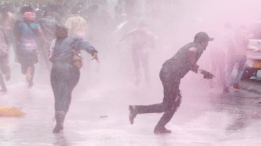 <div class="paragraphs"><p>People run after police use water cannon to disperse protesters in Kenya.</p></div>