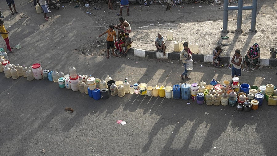 <div class="paragraphs"><p>People wait to collect drinking water from a tanker of Delhi Jal Board. (Representative image)</p></div>