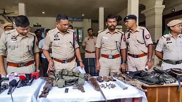 <div class="paragraphs"><p>Police personnel display the arms and ammunition recovered after an encounter with alleged Hmar terrorists, in Cachar district of Assam, Wednesday, July 17</p></div>