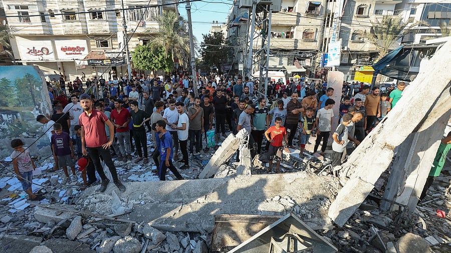 <div class="paragraphs"><p>Palestinians gather at the site of an Israeli air strike on a UN school sheltering displaced people, amid the Israel-Hamas conflict in Nusairat in central Gaza Strip on July 6, 2024. </p></div>
