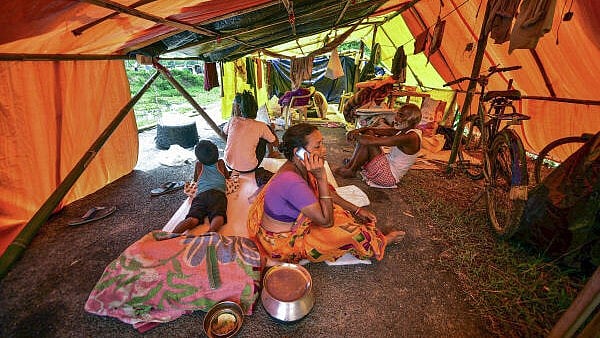 <div class="paragraphs"><p>Residents of a flood affected area take refuge in a makeshift shelter, at Kaliabor, in Nagaon district, Assam.</p></div>