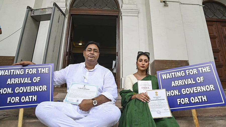 <div class="paragraphs"><p>In this image take on June 26, Rayat Hossain Sarkar (left) and Sayantika Banerjee wait on the West Bengal Legislative Assembly premises for their swearing-in ceremony.</p></div>
