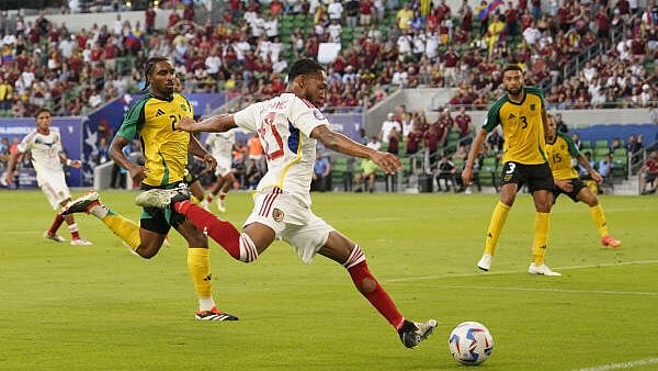 <div class="paragraphs"><p>Venezuela midfielder José Andrés Martínez (13) dribbles towards the goal while defended by Jamaica defender Jon Bell (21) during the second half at Q2 Stadium in Austin, Texas, US on June 30, 2024.</p></div>