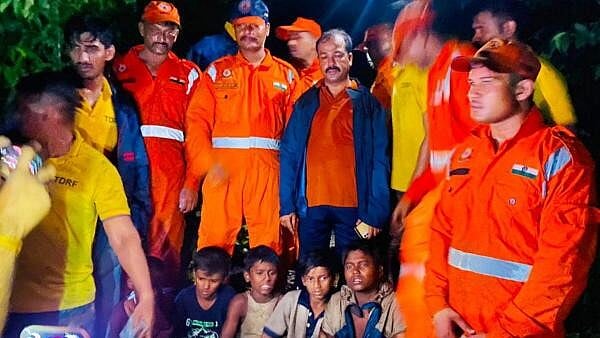 <div class="paragraphs"><p>NDRF personnel with five boys, who went to catch crabs on a hill but lost their way, after rescuing them in an overnight operation, in Thane.</p></div>