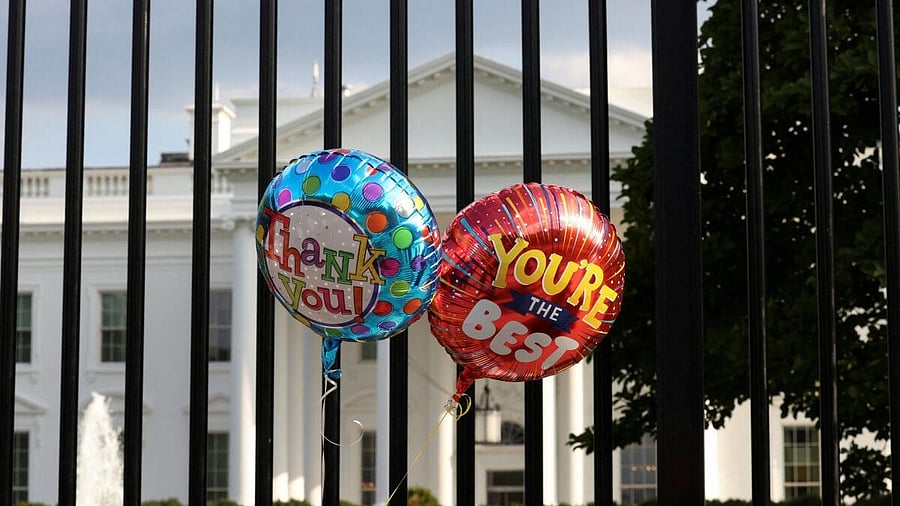 <div class="paragraphs"><p>Balloons that were tied to the fence are pictured as people gather outside the White House after US President Joe Biden announced he is stopping his bid for reelection</p></div>